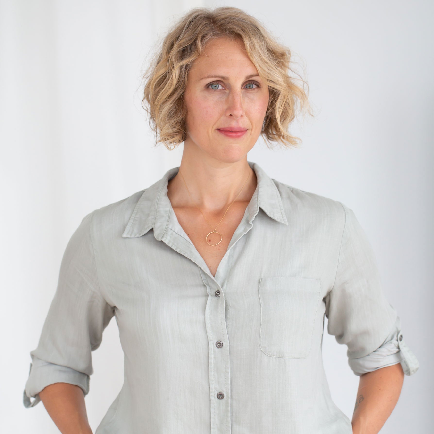 Photo of Dr. Deena Kara Shaffer wearing a light blue button down shirt
