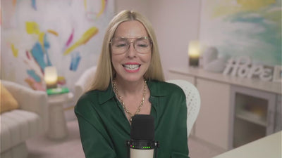 Gina addresses members from her home studio, wearing a forest green blouse